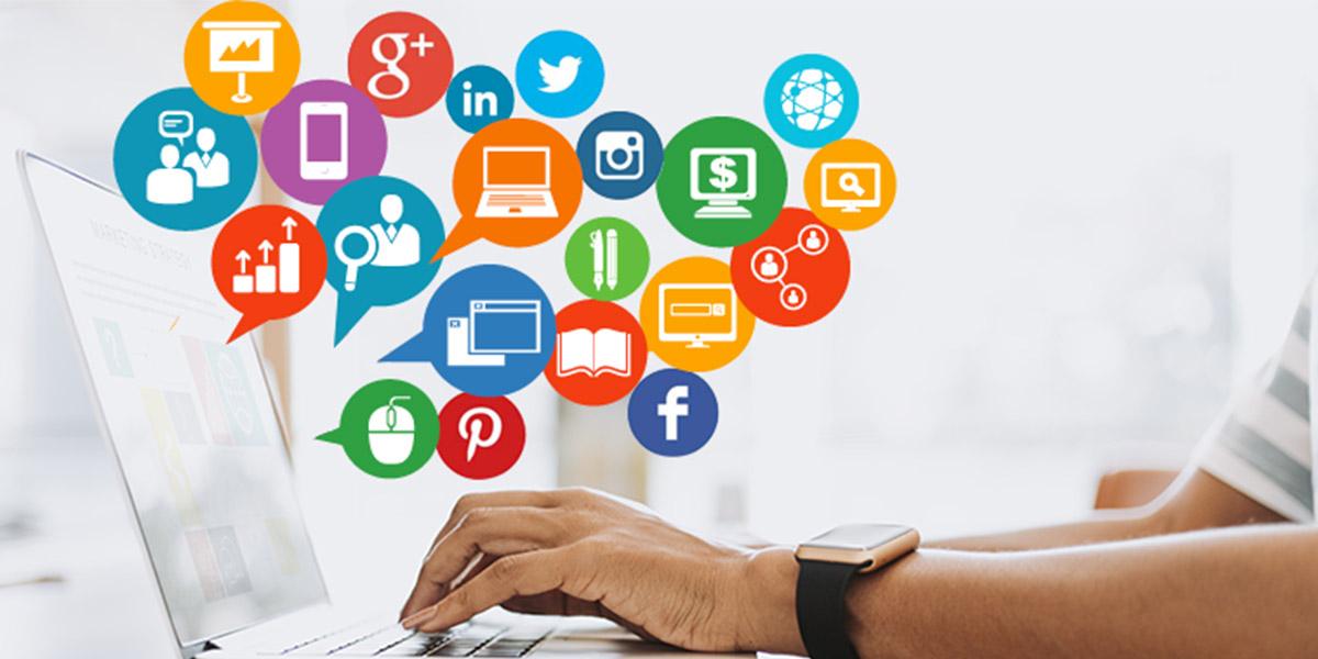 Hands on a laptop surrounded by social media and digital marketing icons